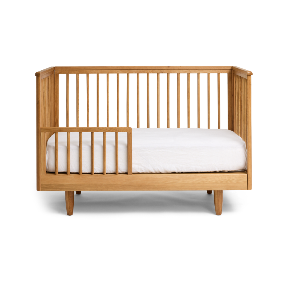 Wooden George Cot with a conversion Toddler kit with a white mattress on a white background