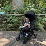 Baby smiling in a Lucci pram