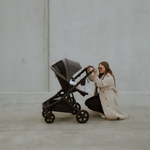 Mother with baby inside a Olive pram