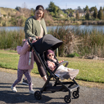 Family together and baby inside a Lucci travel pram
