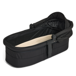 Black baby carry cot with beige interior on a white background