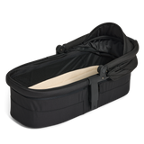 Black baby carry cot with beige interior on a white background
