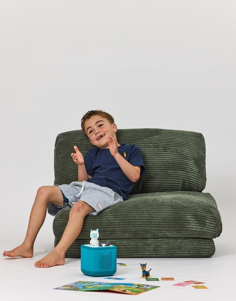 Frankie sitting on a Rylee Recliner - Green