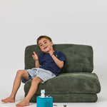 Frankie sitting on a Rylee Recliner - Green