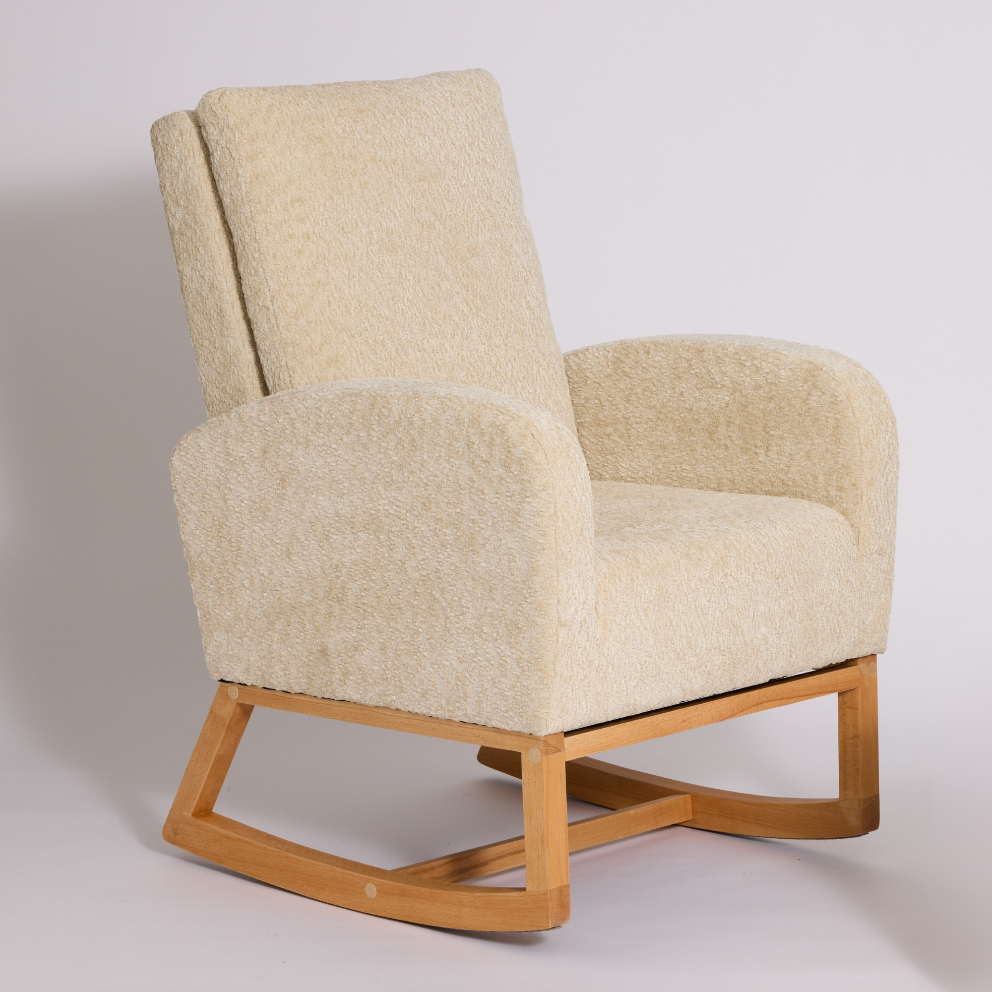 Myla Nursing Chair with textured cream bouclé upholstery and a light natural wood rocking base, photographed against a neutral light gray studio background.