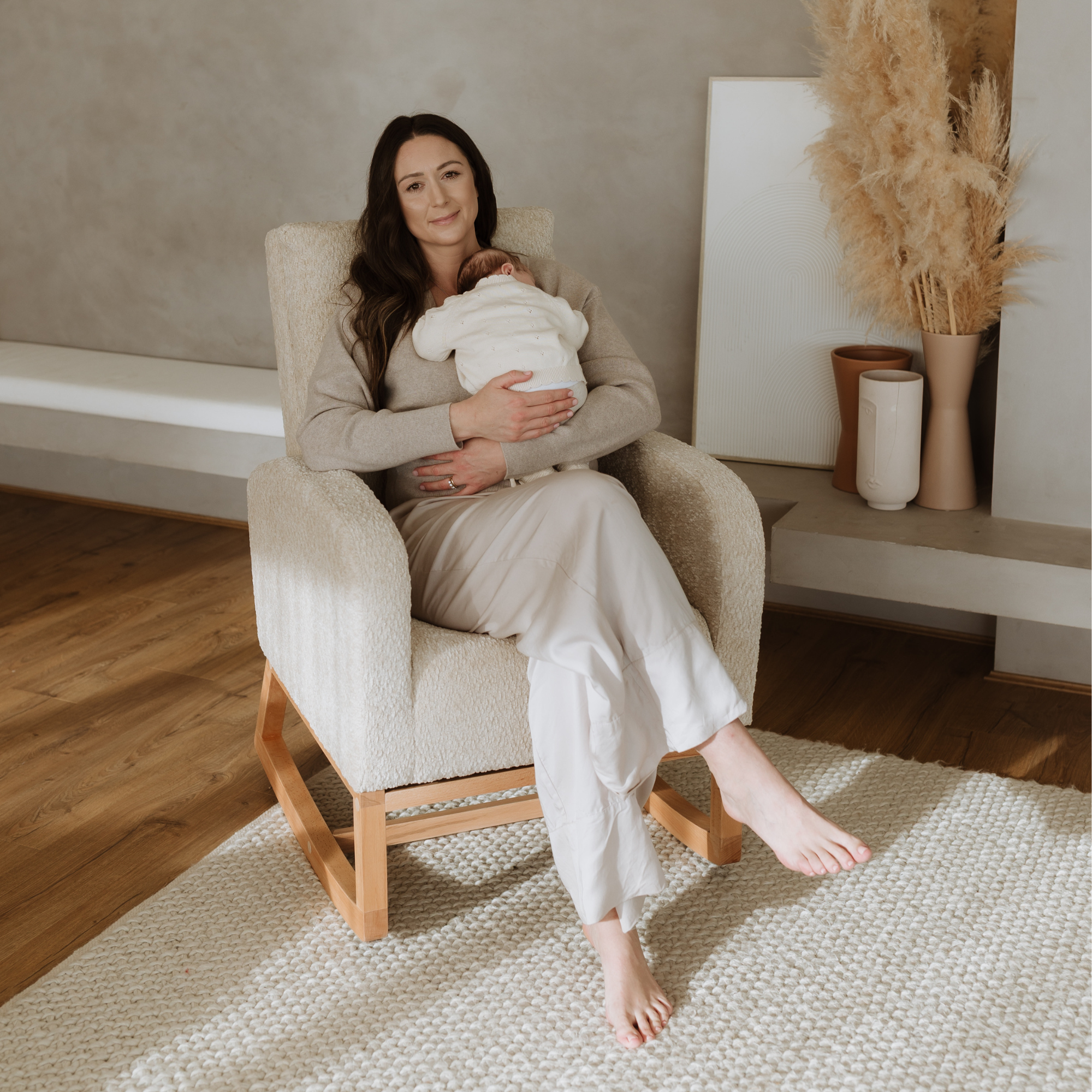 Mother holding a baby in a Myla Rocking Chair