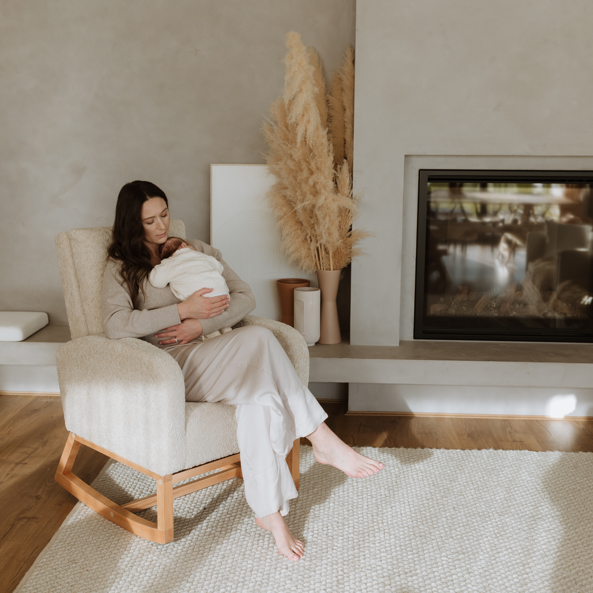 Mother with her little one in a Myla Nursing Chair in a living room