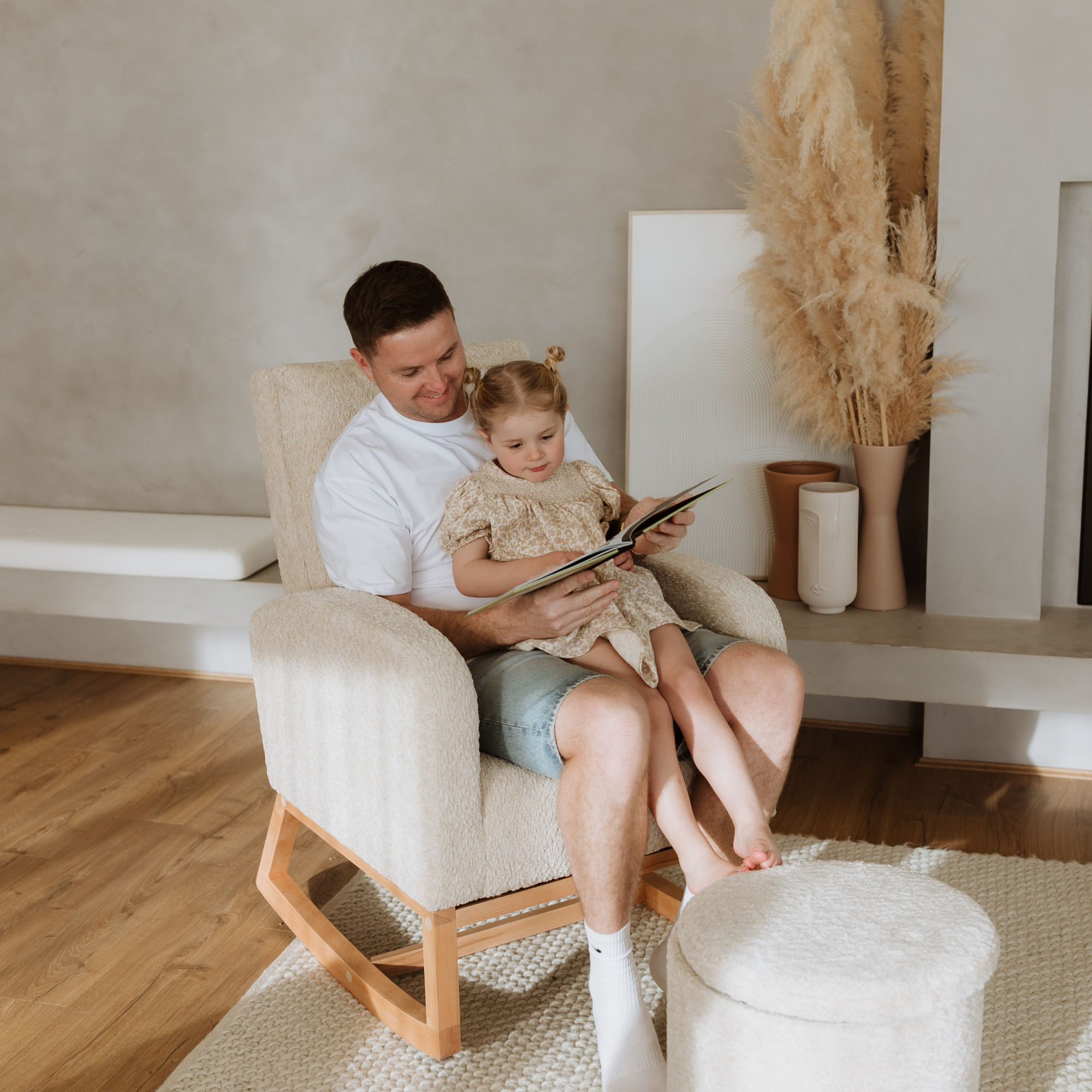 Father with daugher reading a book in a Myla Nursing Chair