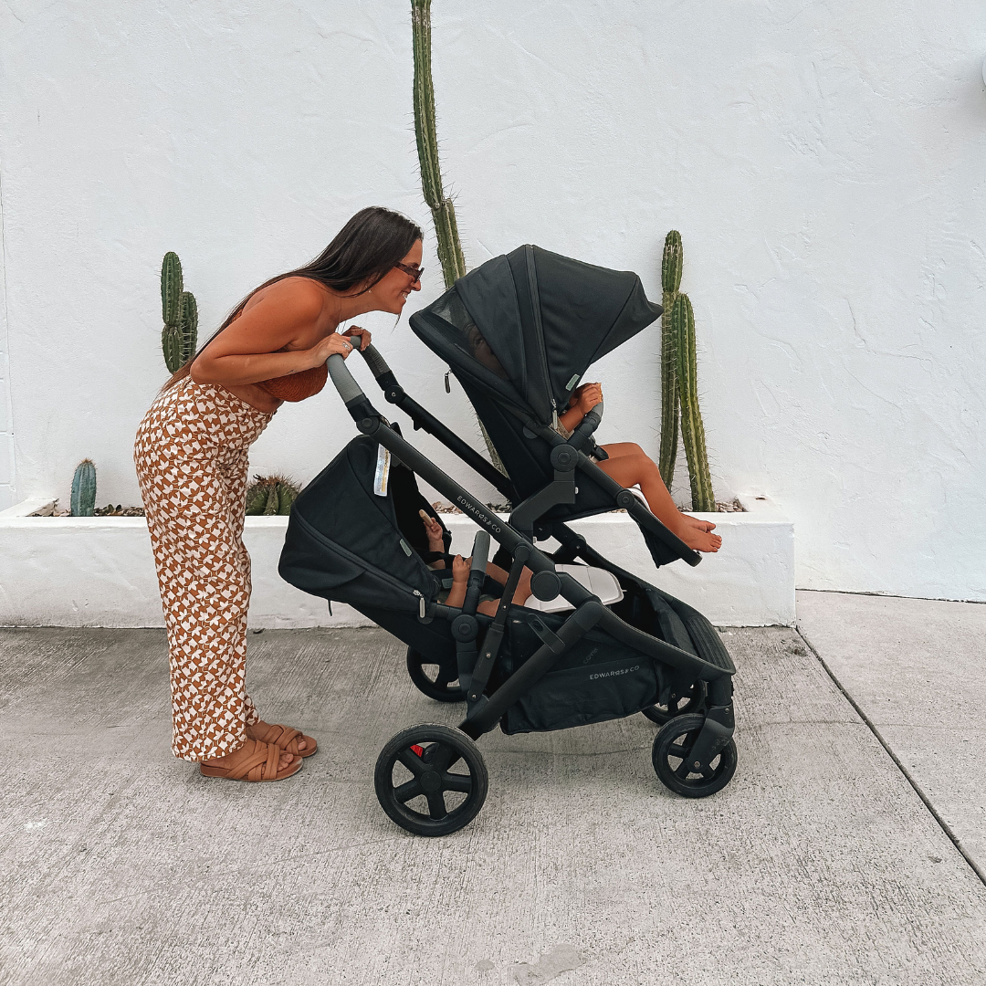 Mother with two kids inside Olive Double pram