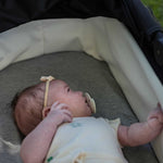 Baby in a carry cot with Bamboo Fitted Sheets